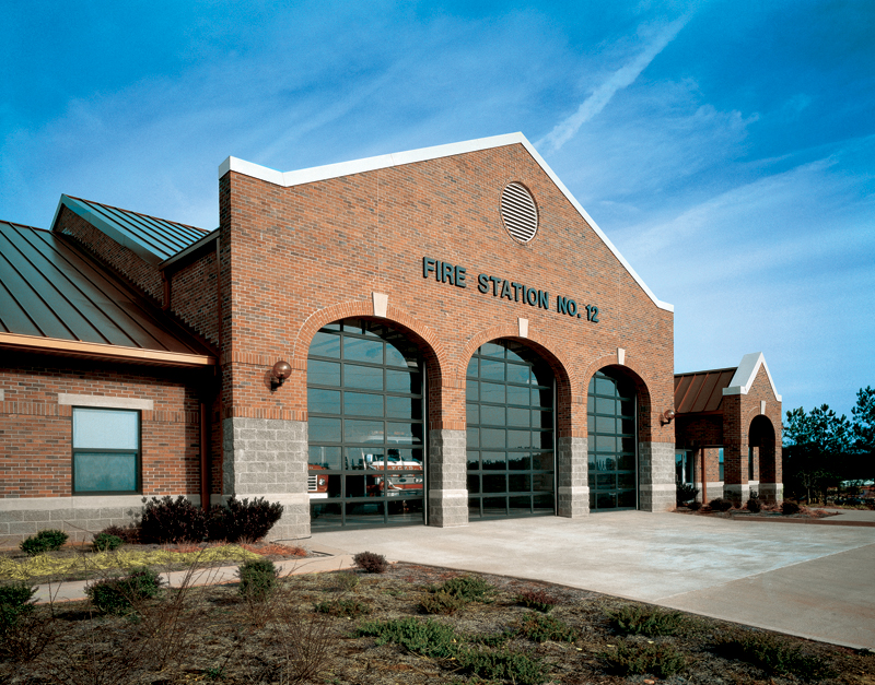 Overhead garage doors installed in a large brick fire station